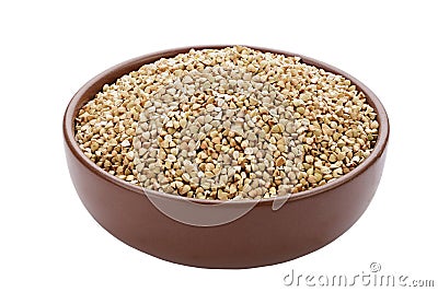 Unroasted buckwheat in a bowl. Useful dietary product. Isolated on a white background Stock Photo