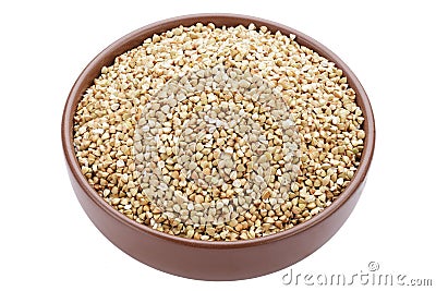 Unroasted buckwheat in a bowl. Useful dietary product. Isolated on a white background Stock Photo