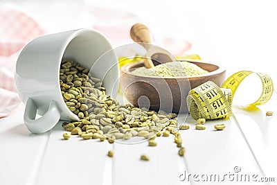 Unroasted green coffee beans on white table Stock Photo