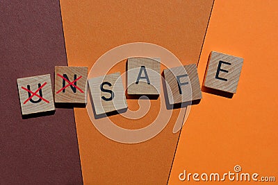 Unsafe, word in wooden alphabet letters Stock Photo