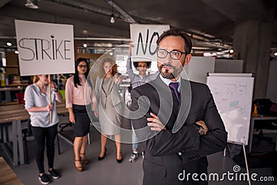 Unsatisfied employees on strike in the office. Stock Photo