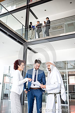 Unsatisfied managers at meeting with Arabian man Stock Photo