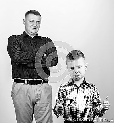 Unsatisfied with work done. childhood. trust and values. fathers day. father and son in business suit. fashion. happy Stock Photo