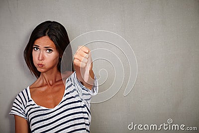 Unsatisfied young lady showing disapproval sign Stock Photo