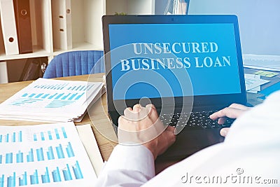 Unsecured Business Loan concept. Man with the laptop Stock Photo