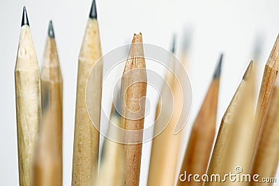 Unsharpened pencil in focus on beam of natural wood pencils Stock Photo