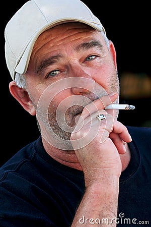 Unshaven Man Smoking Cigarette Stock Photo