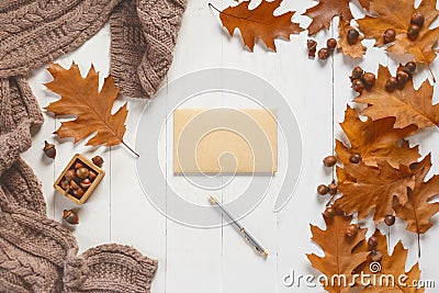 Unsigned envelope and pen on white wooden table with autumn accessories. View from above Stock Photo