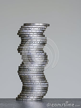 Unstable coins stack of two euro coins on a grey background, future balance concept Stock Photo