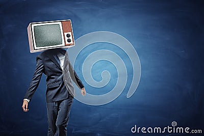 An unsteady businessman standing unevenly with a large retro TV on his head showing gray noise. Stock Photo