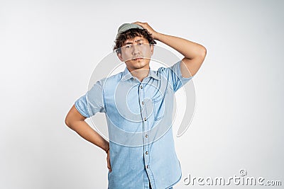 unsure asian young man thinking on isolated background Stock Photo