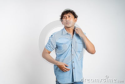 unsure asian young man thinking on isolated background Stock Photo