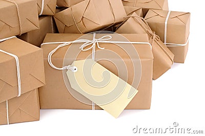 Pile of brown paper parcels or packages with manila label isolated on white Stock Photo