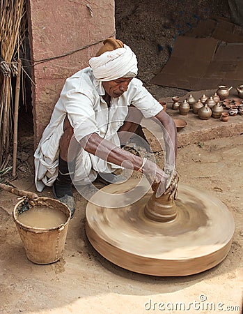 Untouchable Caste Indian Man at Pottery Wheel with Many Pots Editorial Stock Photo