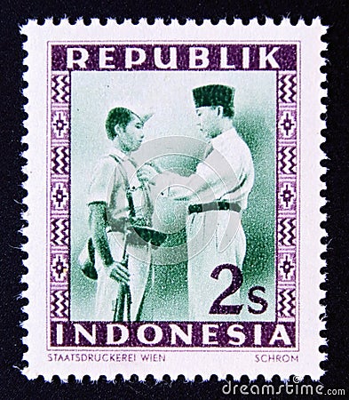 Unused postage stamp Republic Indonesia 1949, President Soekarno decorates a soldier Editorial Stock Photo