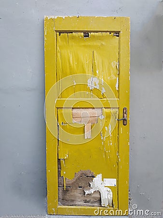 unused yellow door, leaning against the wall Stock Photo