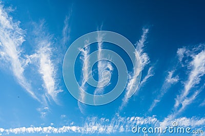 An unusual celestial landscape with white clouds. White puffy clouds in the form of rays spread out from the horizon. A lonely Stock Photo