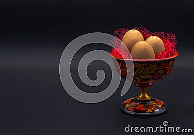 Unusual Easter on dark background. Brown eggs in hohloma vase on black background. Copy space for your text. Easter Stock Photo