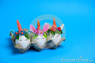Cute unusual Easter unicorn eggs on a blue background with copy space Stock Photo