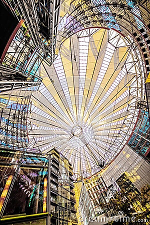 an unusual light roof over the Sony center in Berlin and its reflection in the glass windows of an office building Editorial Stock Photo