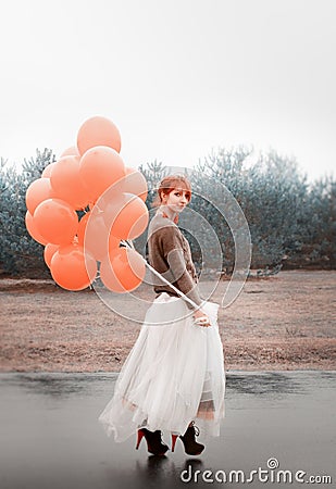 Unusual woman with balloons as concept outdoors Stock Photo
