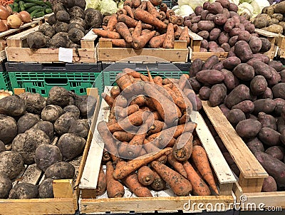 Unwashed carrots, beets and potatoes in a supermarket Stock Photo