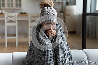 Unwell woman feel cold in home with no heating Stock Photo