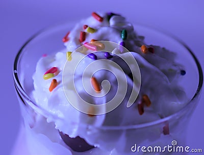 A delicious macro view of dessert topping with sprinkles and whip cream Stock Photo