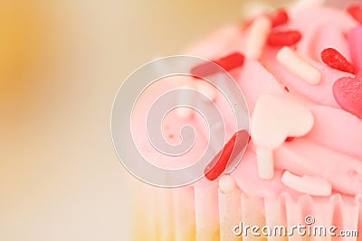 An up close pink frosted cupcake. Stock Photo