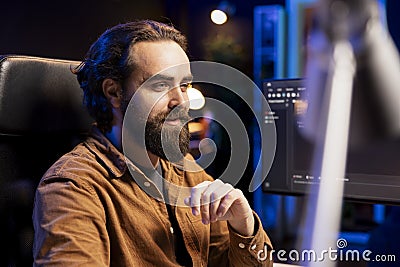Upbeat developer content with installed fortified code preventing cyberattacks Stock Photo