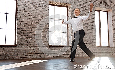 Upbeat senior man performing classical dance at the ballroom Stock Photo