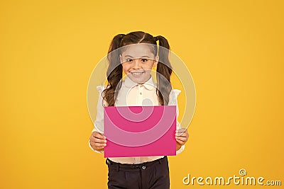 Upcoming event. Look here. Girl school uniform hold poster. Schoolgirl hold poster copy space. News information Stock Photo