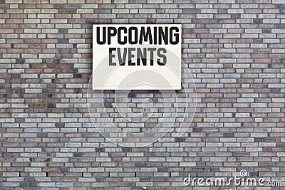 Upcoming Events message on Brick wall with light box Stock Photo