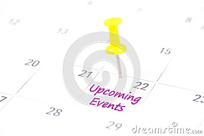 Upcoming Events written on a calendar with a yellow push pin to Stock Photo