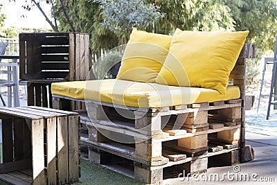 Upcycled outdoor seat made from pallets with wood crate as table Stock Photo