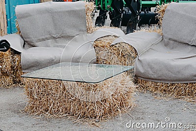 Upcycling ideas, Recycle crafts for home. coffee table and chair made of straw bales. Alternative eco-friendly furniture Stock Photo