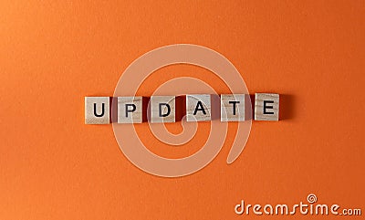 Update word phrase in wooden letters. Motivation and slogan. Orange background Stock Photo