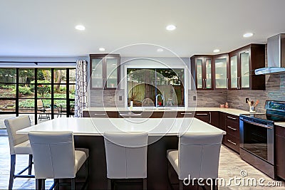 Updated contemporary kitchen room interior in white and brown tones. Stock Photo