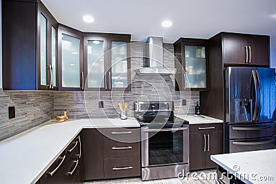 Updated contemporary kitchen room interior in white and dark tones. Stock Photo