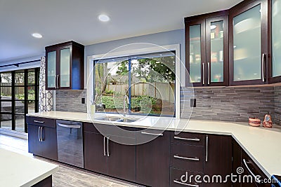 Updated contemporary kitchen room interior in white and dark tones. Stock Photo