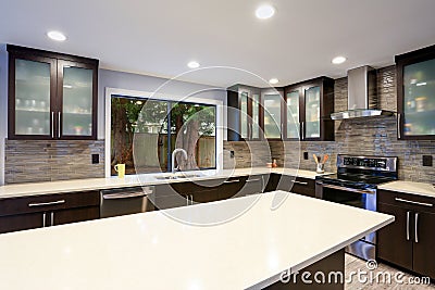 Updated contemporary kitchen room interior in white and dark tones. Stock Photo