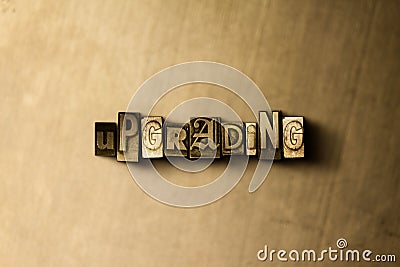 UPGRADING - close-up of grungy vintage typeset word on metal backdrop Stock Photo