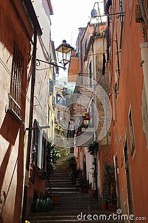 An uphill street in Monterosso. Flight of steps winding between two rows of colourful houses Stock Photo