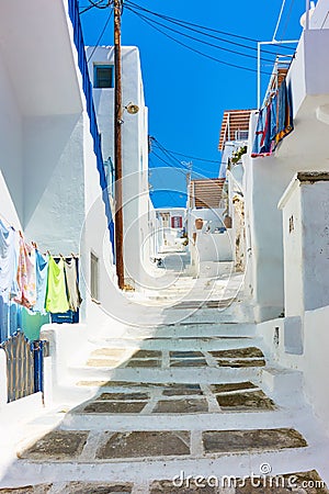 Uphill street with old white houses in Mykonos Stock Photo