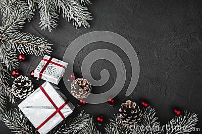 Upper, above, top view of pine, evergreen, and Christmas red glass toys, presents on stone background. Stock Photo