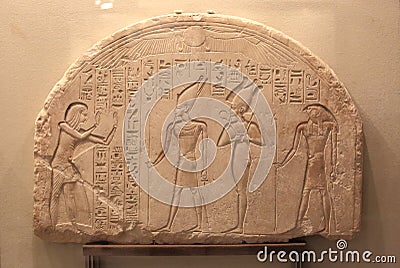 Commander-in-chief Haremhab before the gods Atum, Osiris and Ptah-Sokar. Ancient Egyptian stele from the Hermitage collection Editorial Stock Photo