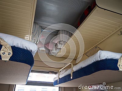 Upper shelves in second-class compartment wagon Stock Photo