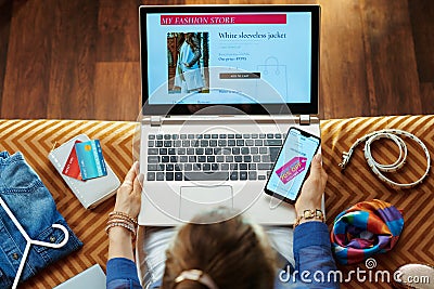 Woman browsing high fashion retail online store on laptop Stock Photo