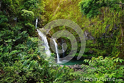 Upper Waikani Falls also known as Three Bears, a trio of large waterfalls amid rocks & lush vegetation with a popular swimming hol Stock Photo