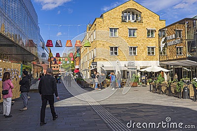 Uppsala downtown cityscape view. Colorful lamps decorating pass between buildings. People enjoy warm weather. Sweden. Editorial Stock Photo